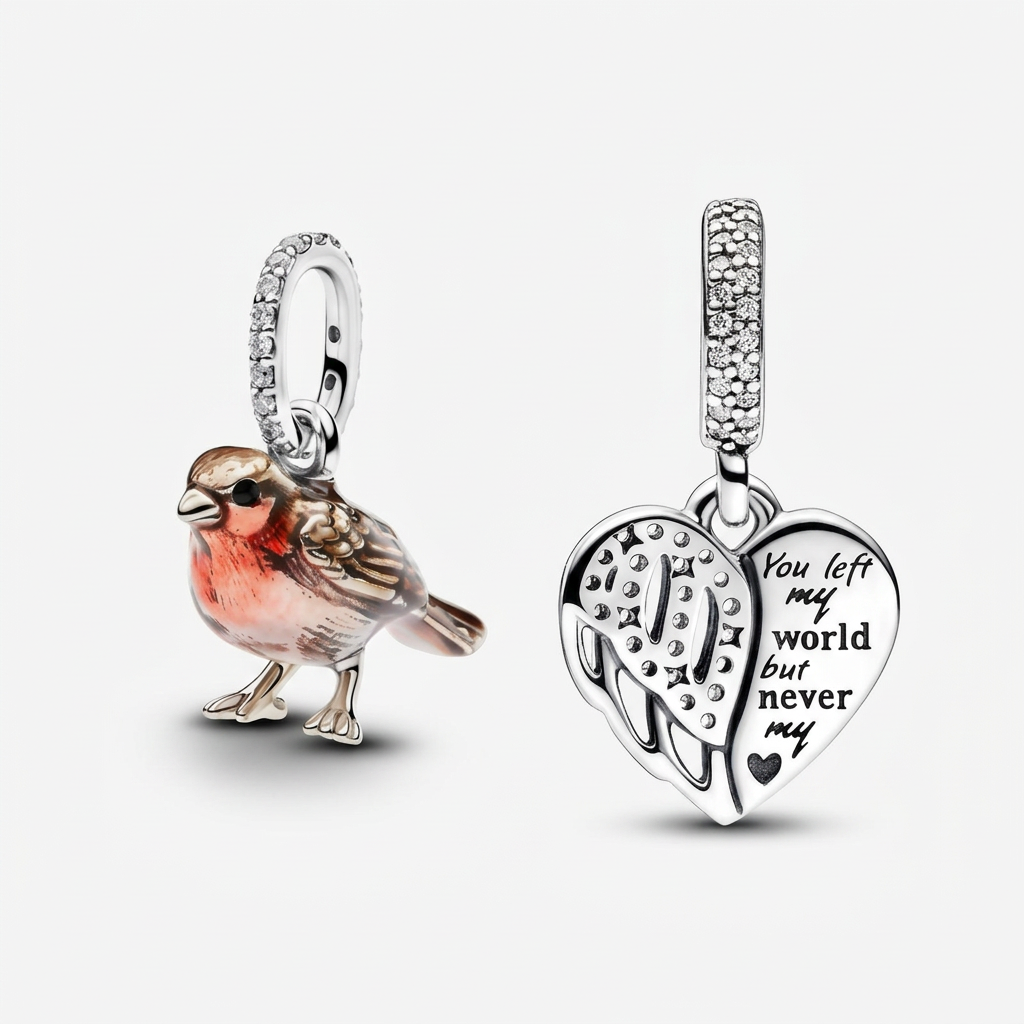 Robin bird dangle charm beside a heart and angel wing dangle charm on a white background