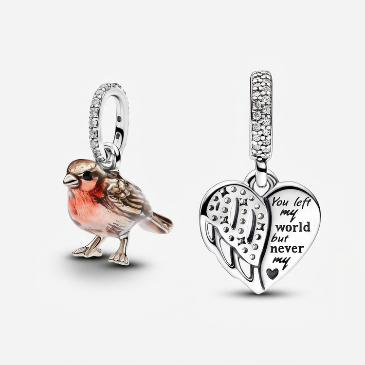Robin bird dangle charm beside a heart and angel wing dangle charm on a white background