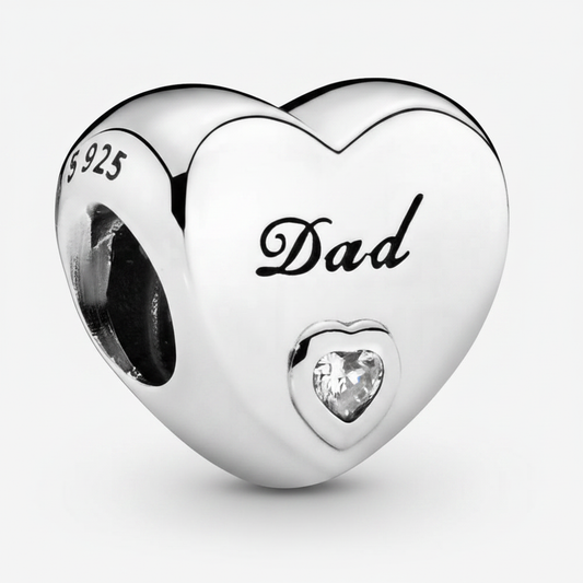 Close-up macro detail of Dad 925 sterling silver heart charm with engraved script and clear CZ stone